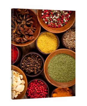 Various kind of spices in wooden bowls