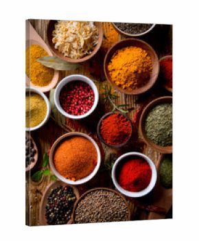 Assorted spices on wooden background