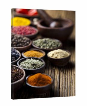 Assortment of spices in wooden bowl background 