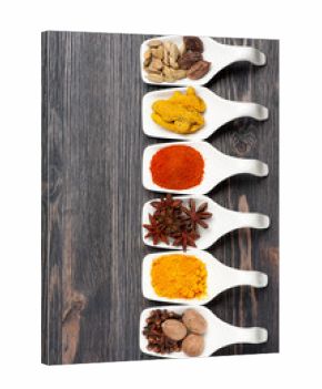 Various colorful spices on a vintage board