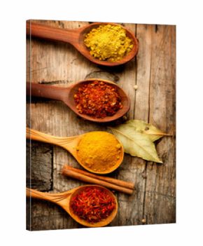 Various spices and herbs over wooden background