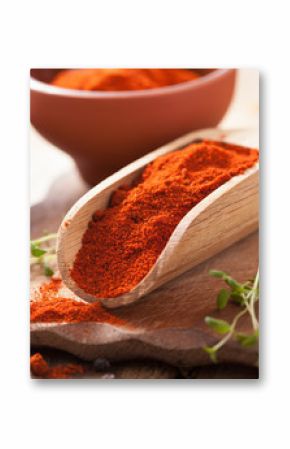 red ground paprika spice in wooden scoop and bowl