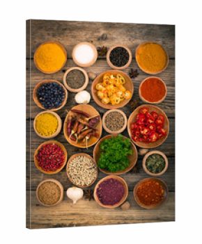 Various spices and herbs on the wooden background