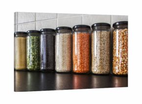 Health Food - herbs, seeds and pulses in spice jars.