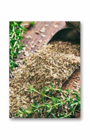 Fresh and dried thyme on a wooden table