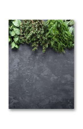 fresh herbs on dark stone background with space for text