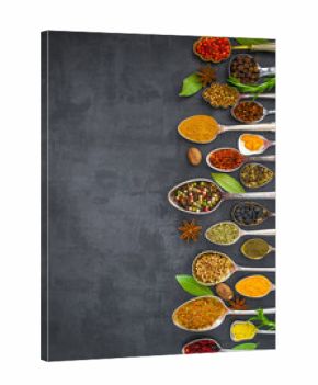 Various spices spoons on stone table. Top view .