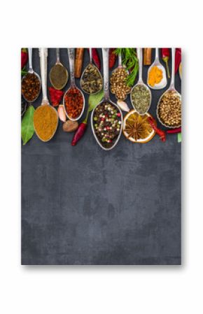 Various spices spoons on stone table. Top view .