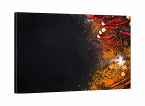 Variety Spices and herbs on black stone background, Top view with empty space background for texture. Italian food, eastern food concept.