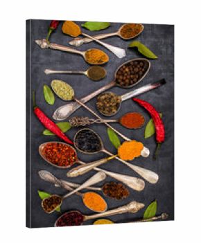 Various spices spoons on stone table. Top view .