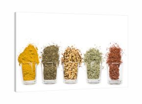 glass jars with various spices on white background with copy space