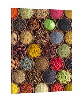 Colorful spices and herbs background. large set of seasonings in cups, top view