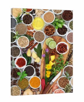 Herb and spice seasoning with fresh and dried herbs, spices and edible flowers on olive wood board and rustic background  Top view.