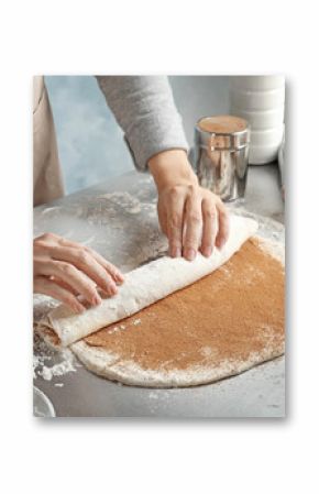 Woman making cinnamon rolls at table, closeup