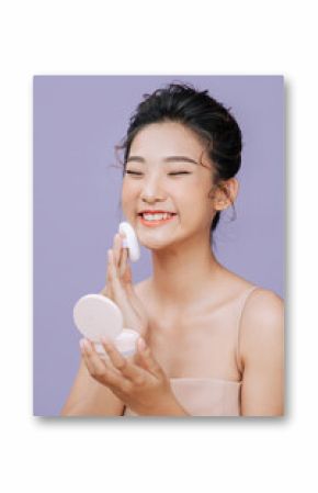 Asian female applying powder to her face