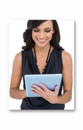 Smiling elegant brown haired model typing on tablet