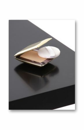 Makeup compact powder on black table isolated on white backgroun