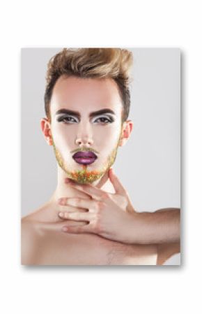 Charming male model with makeup and multicolor beard