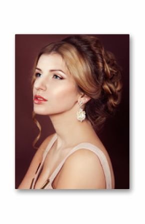 Studio portrait of a beautiful dark blond woman with evening hai