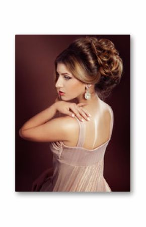 Studio portrait of a beautiful dark blond woman with evening hai