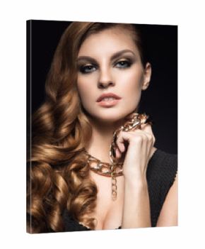 Beautiful brunette woman with perfect skin, bright makeup and gold jewelry. Beauty face. Picture taken in the studio on a grey background