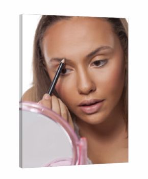 girl shaping her eyebrows with a pencil for eyebrows