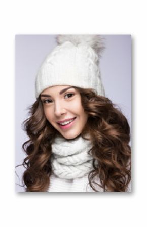 Beautiful girl with gentle makeup, curls and smile in white knit