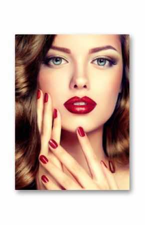 Beautiful model with curly hair and red manicure closeup . fashion trend image ,the girl with blue eyes , fashion makeup and red nails