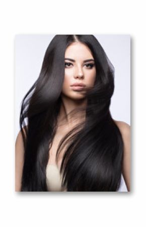 Beautiful brunette girl in move with a perfectly smooth hair, and classic make-up. Beauty face. 