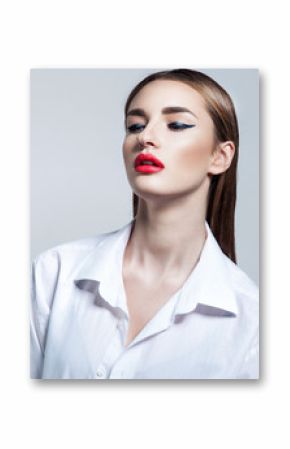 High fashion make up of young woman in white shirt. Red lips and