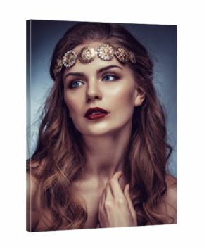 Beautiful young blonde woman with long hair with a diadem in the Greek style