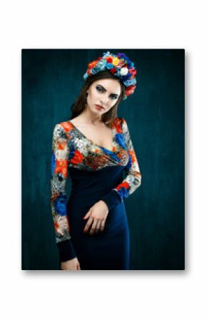 Sensual woman in floral wreath. Portrait of beautiful young woman with red lips dressed in a bright blouse. Beauty Woman. Beautiful Brunette Luxury Girl. Healthy Long Black Hair and Holiday Makeup.