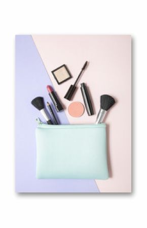 Aerial view of make up products spilling out of a pastel blue cosmetics bag, on a pink and purple background