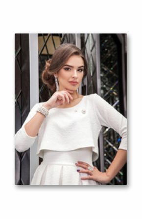 portrait of a beautiful young girl in a white dress on a backgro