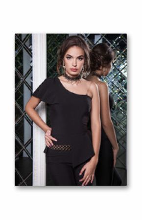 portrait of a beautiful young girl dressed in black on a backgro