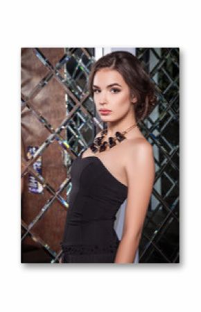 portrait of a beautiful young girl dressed in black on a backgro