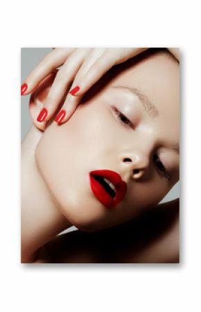 Beautiful woman with red matte lipstick. Beautiful woman face. Makeup detail. Beauty girl with perfect skin. Red lips and nails manicure