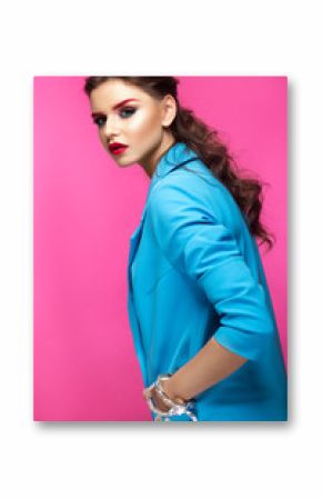 Beautiful girl in blue suit on pink background with creative make-up and fashionable style. Beauty face. Photo taken in the studio.
