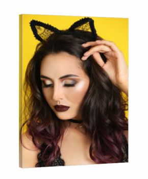 Beautiful young woman with cat ears on color background