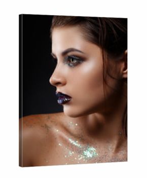 Beautiful woman's face with gorgeous make-up close-up