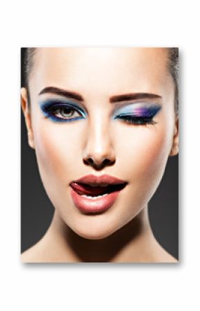 Beautiful face of an young woman with blue makeup of eyes