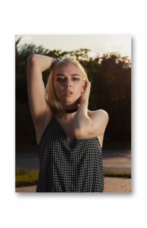 Closeup portrait of wonderful blonde woman wearing chocker and sarafan, posing in the city at the evening