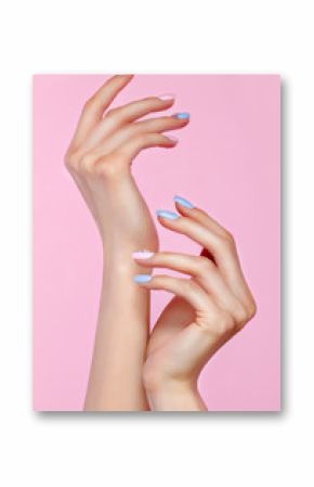 Beautiful pink and blue manicure with crystals on female hand. Close-up. Picture taken in the studio