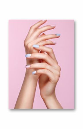 Beautiful pink and blue manicure with crystals on female hand. Close-up. Picture taken in the studio