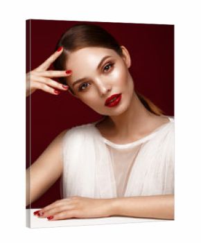 Beautiful girl in white dress with classic make-up and red manicure. Beauty face. Photo taken in the studio.