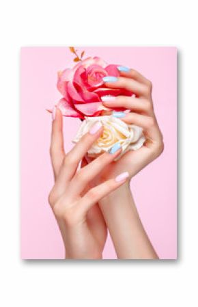 Beautiful pink and blue manicure with crystals on female hand. Close-up. Picture taken in the studio