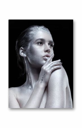 Beauty portrait of young gorgeous woman. Female with hand near face  on black background