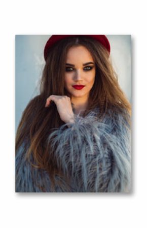 Portrait of a girl with long hair, red lips and a hat