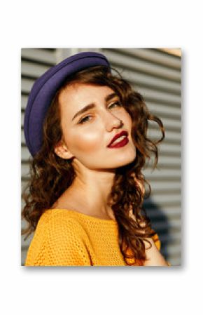 Closeup portrait of wonderful brunette model with red lips and curly hair