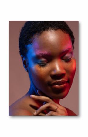 African american woman with short hair and colourful make up touching shoulder with eyes closed